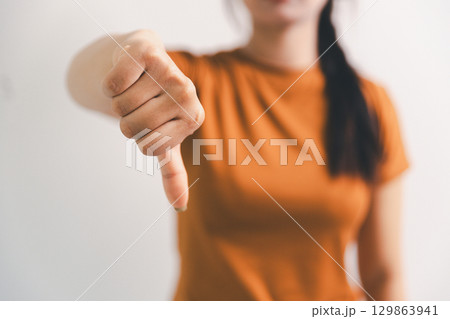 Asian girl expresses dislike, person express negative feeling, concept business complaint from customer ensuring employee satisfaction negative feedback to prevent mental strain customer dislike 129863941