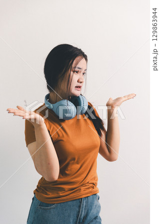 Asian girl expresses dislike, person express negative feeling, concept business complaint from customer ensuring employee satisfaction negative feedback to prevent mental strain customer dislike Asian girl expresses dislike, person express negative feeling, concept business complaint from customer ensuring employee satisfaction negative feedback to prevent mental strain customer dislike 129863944