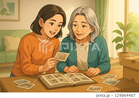 写真を見ながら思い出を語る 129864487