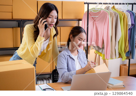 Two asian woman e-commerce startup in home office, two young entrepreneur management order. 129864540