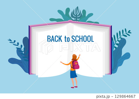 Back to school, the student girl stands in front of an open book of knowledge 129864667