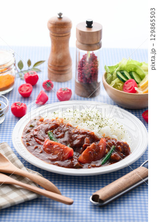 ほかほかと香り立つトマトカレーと白ごはんの盛り付け サラダ付き家庭料理の食卓イメージ ほかほかと香り立つトマトカレーと白ごはんの盛り付け サラダ付き家庭料理の食卓イメージ 129865503