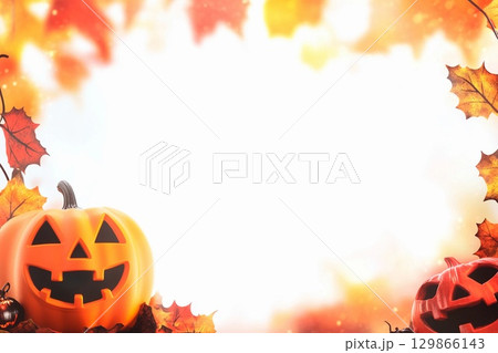 Blank Halloween card background decorated with pumpkins and autumn leaves for festive celebration Blank Halloween card background decorated with pumpkins and autumn leaves for festive celebration 129866143
