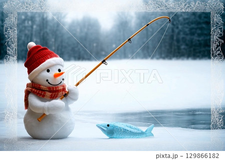 Snowman with fishing pole sits on snowy bank by frozen lake waiting for bite during winter day 129866182