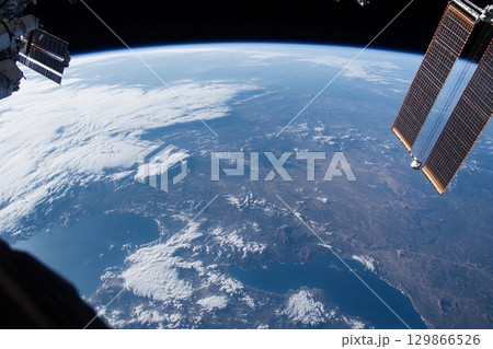 View of Earth from space captured during low-light conditions showcasing urban lights and natural atmosphere 129866526