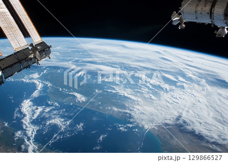View of Earth from space captured during low-light conditions showcasing urban lights and natural atmosphere 129866527