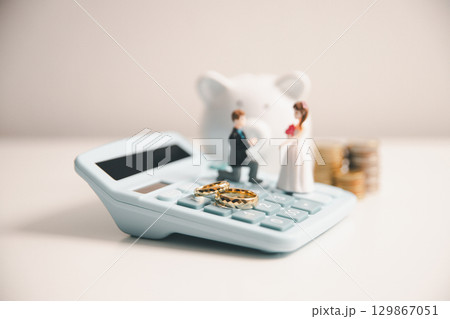 Save money for wedding and planning wedding concept. Sustainable financial goal for family life or married life. Miniature wedding on rows of rising coins, depicts savings or growth for new family. Save money for wedding and planning wedding concept. Sustainable financial goal for family life or married life. Miniature wedding on rows of rising coins, depicts savings or growth for new family. 129867051