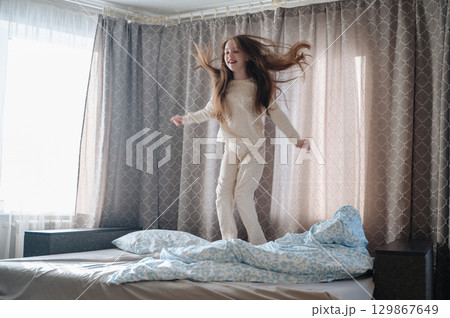 A girl with long hair enjoys a peaceful awakening early in the morning. A girl with long hair enjoys a peaceful awakening early in the morning. 129867649