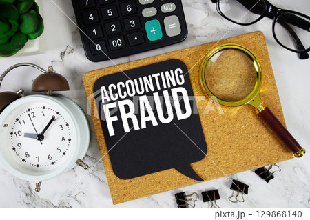 Accounting Fraud text with Calculator, alarm clock and magnifying glass on marble background Accounting Fraud text with Calculator, alarm clock and magnifying glass on marble background 129868140