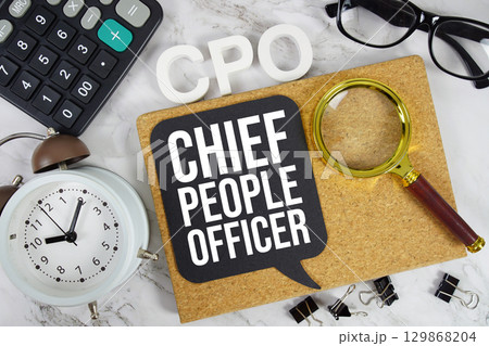 CPO Chief People Officer text with Calculator, alarm clock and magnifying glass on marble background 129868204