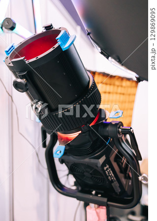 Professional studio LED spotlight close-up. Modern equipment for film, television and photo studios. Advertising shooting Professional studio LED spotlight close-up. Modern equipment for film, television and photo studios. Advertising shooting 129869095