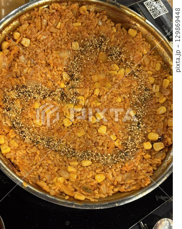 Korean-style Bokkeumbap (fried rice) packed with vibrant flavors, mixed vegetables, and savory seasonings. A classic comfort food thats both satisfying and versatile, ideal for any meal. 129869448
