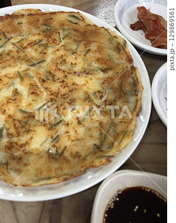Golden-brown gamja jeon, a classic Korean potato pancake, crispy on the outside and tender inside. Simple yet flavorful, it's a comforting snack or side dish to enjoy anytime. Golden-brown gamja jeon, a classic Korean potato pancake, crispy on the outside and tender inside. Simple yet flavorful, it's a comforting snack or side dish to enjoy anytime. 129869561
