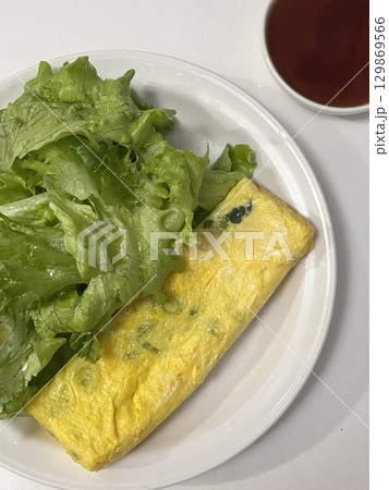 Gyeran-mari or rolled omelette in Korean cuisine is a savory banchan (side dish) made with beaten eggs mixed onion, carrot, Korean zucchini, scallions, and garlic chives. Similiar with tamagoyaki Gyeran-mari or rolled omelette in Korean cuisine is a savory banchan (side dish) made with beaten eggs mixed onion, carrot, Korean zucchini, scallions, and garlic chives. Similiar with tamagoyaki 129869566