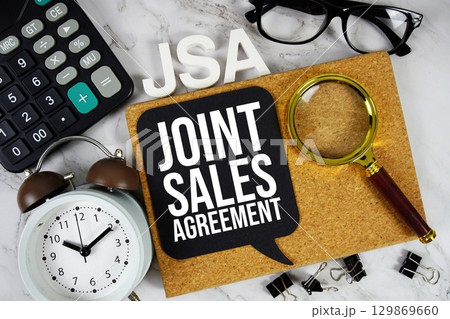 JSA Joint Sales Agreement acronym with calculator, alarm clock and magnifying glass, business concept background JSA Joint Sales Agreement acronym with calculator, alarm clock and magnifying glass, business concept background 129869660