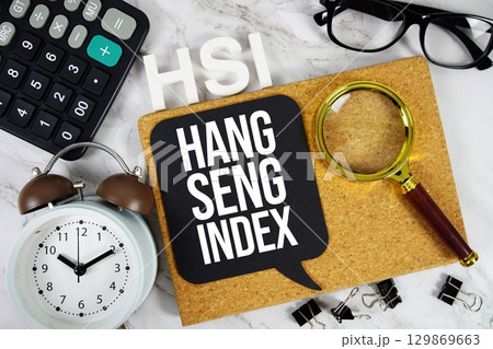 HIS Hang Seng Index acronym with calculator, alarm clock and magnifying glass, Business and Financial concept background 129869663