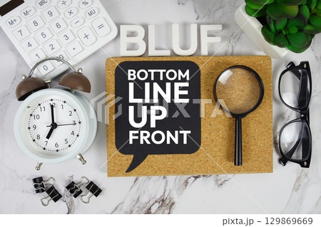 BLUF Bottom Line Up Front acronym with calculator, alarm clock and magnifying glass, Business concept background 129869669