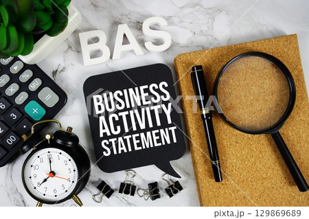 BAS Business Activity Statement acronym with calculator, alarm clock and magnifying glass, business concept background BAS Business Activity Statement acronym with calculator, alarm clock and magnifying glass, business concept background 129869689