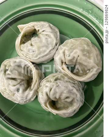 Korean dumplings filled with a mix of savory ingredients like ground meat, tofu, and vegetables. Mandu can be steamed, boiled, or pan-fried, making it a versatile and delicious snack or meal. Korean dumplings filled with a mix of savory ingredients like ground meat, tofu, and vegetables. Mandu can be steamed, boiled, or pan-fried, making it a versatile and delicious snack or meal. 129869824