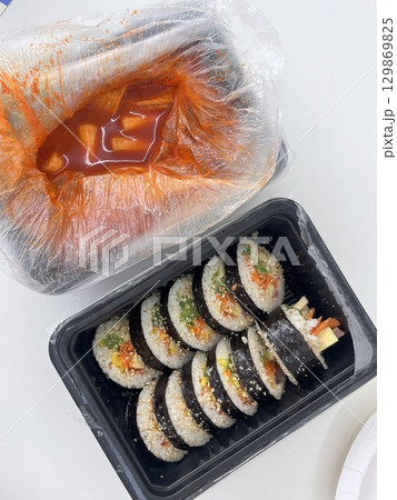 Spicy and chewy tteokbokki paired with fresh and flavorful kimbap rolls filled with rice, vegetables, and protein. A perfect Korean street food combination for a satisfying meal. Spicy and chewy tteokbokki paired with fresh and flavorful kimbap rolls filled with rice, vegetables, and protein. A perfect Korean street food combination for a satisfying meal. 129869825