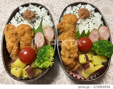 A traditional Korean dosirak, beautifully arranged with rice, assorted banchan, and savory proteins. Balanced and visually inviting, its a portable meal packed with vibrant flavors. A traditional Korean dosirak, beautifully arranged with rice, assorted banchan, and savory proteins. Balanced and visually inviting, its a portable meal packed with vibrant flavors. 129869936