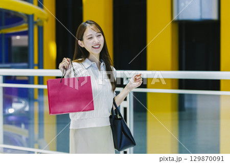 ショッピングモールで買い物をする女性 ショッピングモールで買い物をする女性 129870091