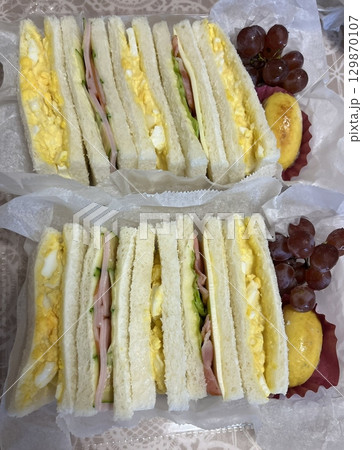 Fluffy and creamy egg sando with soft bread filled with rich, seasoned egg salad. A simple yet satisfying Japanese-style sandwich perfect for breakfast or a quick snack. 129870107