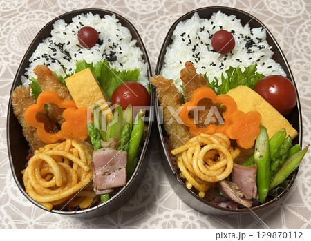 A traditional Korean dosirak, beautifully arranged with rice, assorted banchan, and savory proteins. Balanced and visually inviting, its a portable meal packed with vibrant flavors. A traditional Korean dosirak, beautifully arranged with rice, assorted banchan, and savory proteins. Balanced and visually inviting, its a portable meal packed with vibrant flavors. 129870112