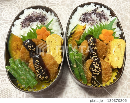 A traditional Korean dosirak, beautifully arranged with rice, assorted banchan, and savory proteins. Balanced and visually inviting, its a portable meal packed with vibrant flavors. A traditional Korean dosirak, beautifully arranged with rice, assorted banchan, and savory proteins. Balanced and visually inviting, its a portable meal packed with vibrant flavors. 129870206