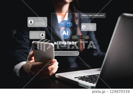 Businesswoman uses chatbot powered by AI technology and artificial intelligence to chat and converse with smart robot system analyzes data to help solve work-related problems. AI chatbot concept. Businesswoman uses chatbot powered by AI technology and artificial intelligence to chat and converse with smart robot system analyzes data to help solve work-related problems. AI chatbot concept. 129870339