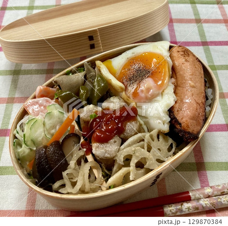 A traditional Korean dosirak, beautifully arranged with rice, assorted banchan, and savory proteins. Balanced and visually inviting, its a portable meal packed with vibrant flavors. 129870384