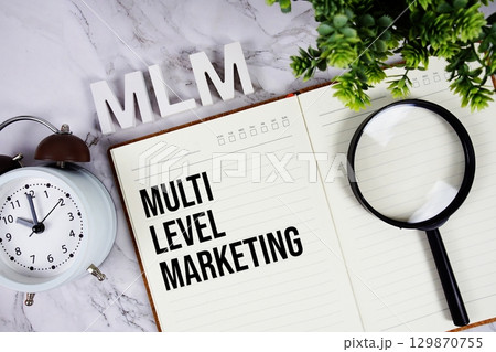 MLM Multi Level Marketing acronym on notepad, Business concept background MLM Multi Level Marketing acronym on notepad, Business concept background 129870755