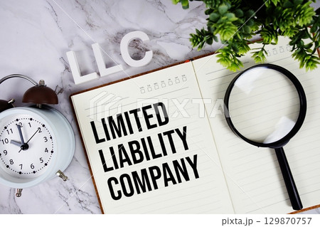 LLC Limited Liability Company acronym on notepad, Business concept background 129870757