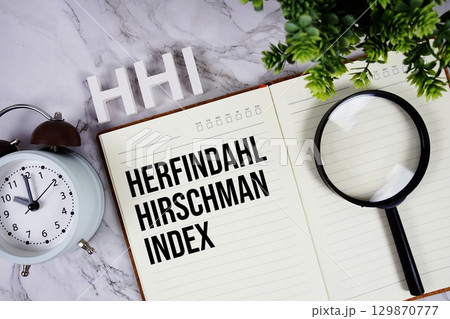 HHI Herfindahl Hirschman Index acronym on notepad, Marketing concept background HHI Herfindahl Hirschman Index acronym on notepad, Marketing concept background 129870777