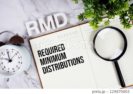 RMD Required Minimum Distributions acronym on notepad, Business concept background 129870803