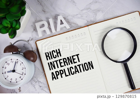RIA Rich Internet Application acronym on notepad, Business concept background RIA Rich Internet Application acronym on notepad, Business concept background 129870815