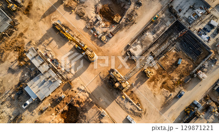 Construction site with crane, excavator, and scaffolding. design for building and development projects top view. 129871221