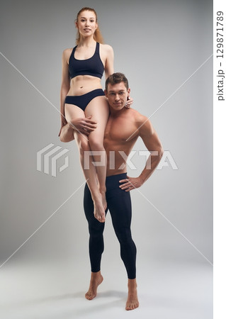 Cheerleader woman and man doing support in studio Cheerleader woman and man doing support in studio 129871789