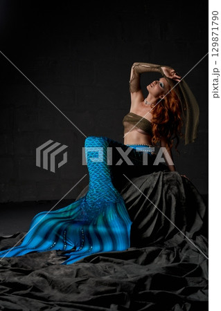 Young alluring mermaid in nets on the ocean floor Young alluring mermaid in nets on the ocean floor 129871790