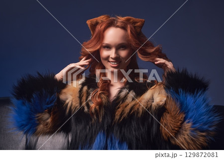 Alluring redhead woman fox showing touching her hair Alluring redhead woman fox showing touching her hair 129872081