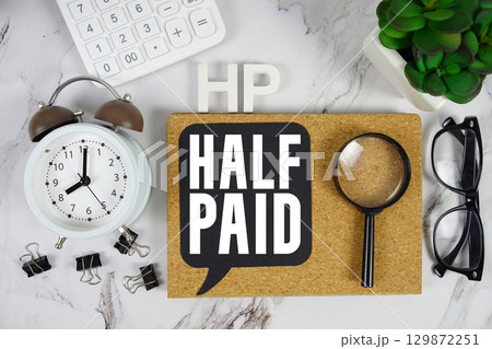 HP Half Paid text with Calculator, alarm clock and magnifying glass on marble background 129872251