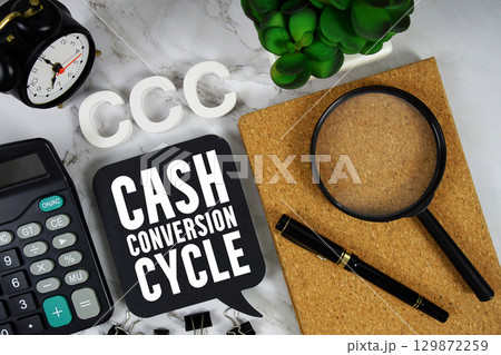 CCC Cash Conversion Cycle text with Calculator, alarm clock and magnifying glass on marble background CCC Cash Conversion Cycle text with Calculator, alarm clock and magnifying glass on marble background 129872259
