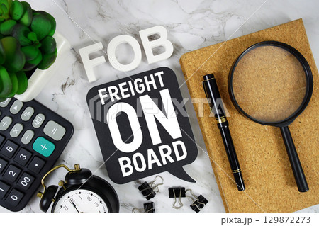 FOB Freight on Board text with Calculator, alarm clock and magnifying glass on marble background FOB Freight on Board text with Calculator, alarm clock and magnifying glass on marble background 129872273