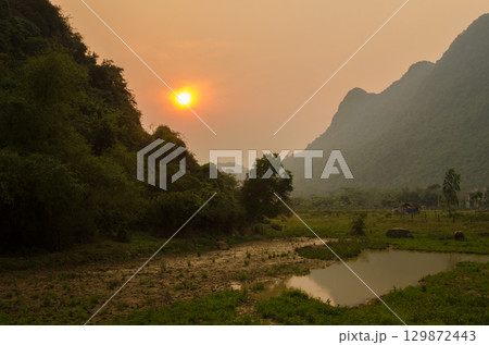 Sunset over a rural landscape. 129872443
