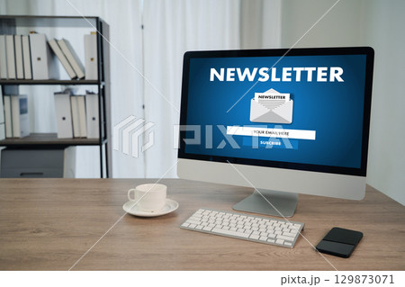 Newsletter subscription concept on desktop computer in modern office workspace with coffee cup  129873071
