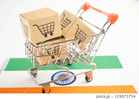 Shopping cart box on India flag, import export, finance commerce. 129873754