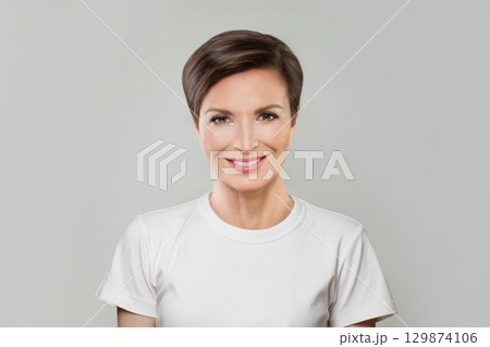 Successful mid aged mature woman looking at camera and smiling. Healthy face skin care beauty 129874106