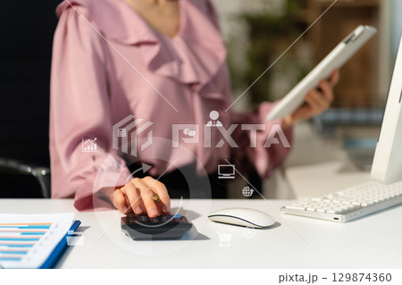Close up woman doing finance at home office with calculate expenses. Close up woman doing finance at home office with calculate expenses. 129874360