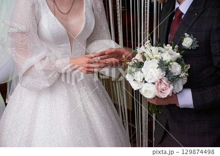 Young couple at the wedding exchanges engagement rings Young couple at the wedding exchanges engagement rings 129874498