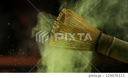 Freeze Motion Detail Shot of Sprinkling Matcha Powder on Stirrer Freeze Motion Detail Shot of Sprinkling Matcha Powder on Stirrer 129876115